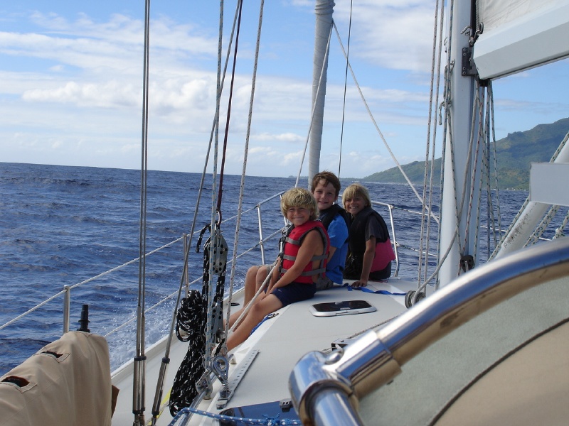 Crew members riding the bow.